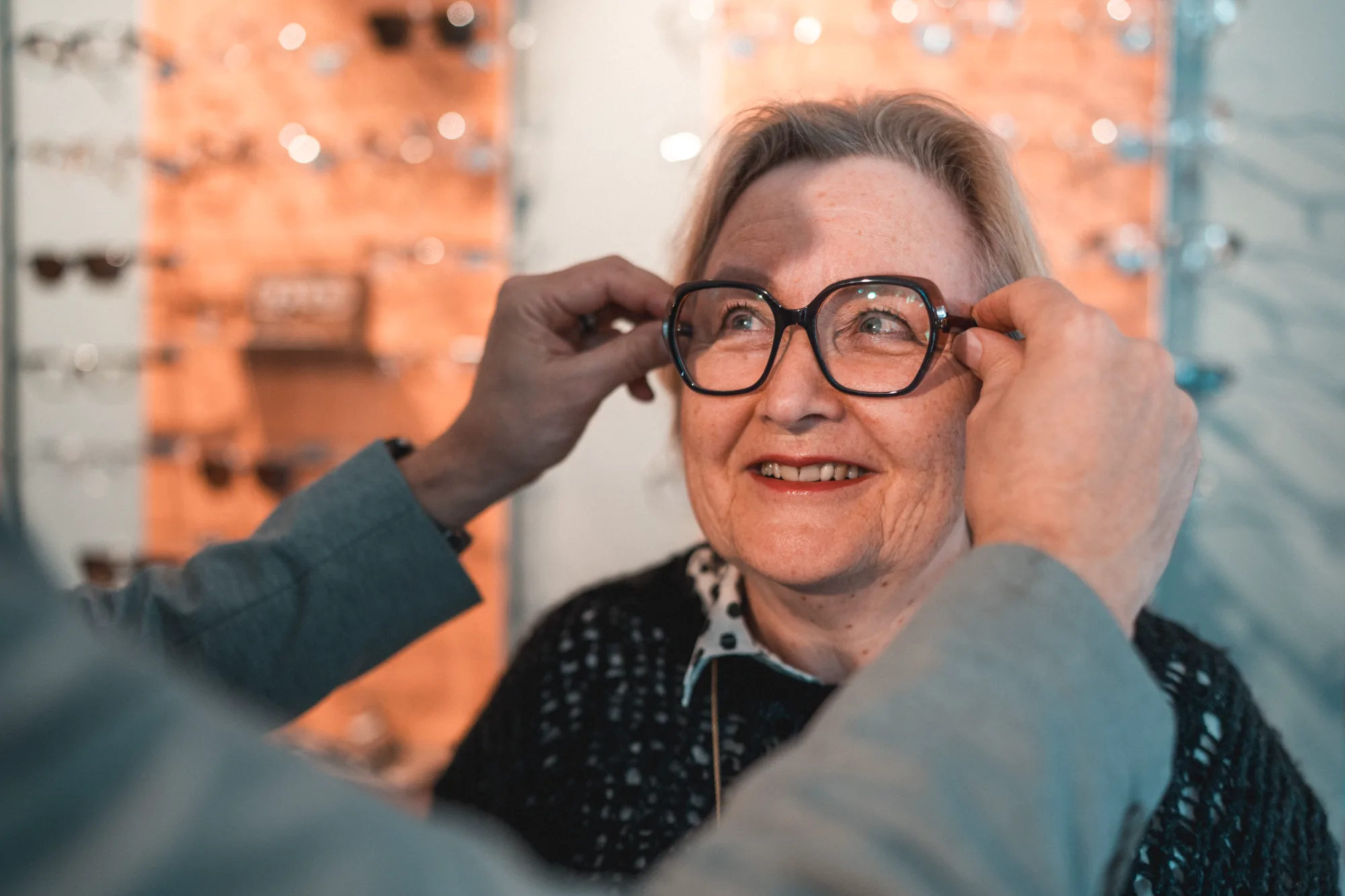 Augenoptikerin passt eine Brille an